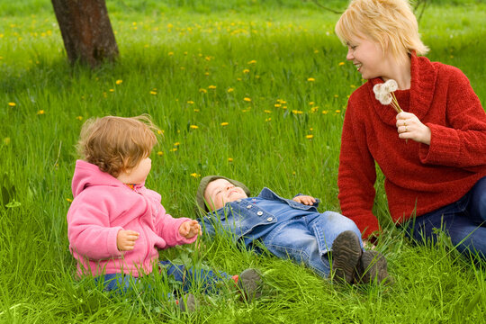 Mother and young children enjoying the spring with seasonal fun activities