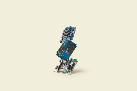 Electronic circuit boards on beige background.