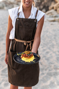 Woman chef plating Tuna tartar