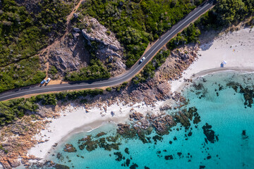 Aerial view of road and crystal clear ocean by the coast