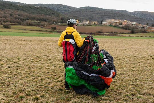 middle age man holding a parachute