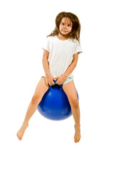 young girl on a  blue space hopper isolated on white