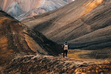 Male Backpacker Hiking Alone In The Wild Mountain