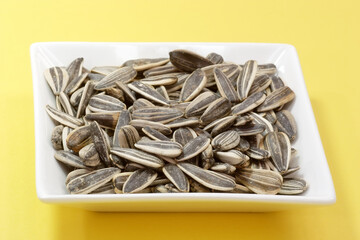 Sunflower seeds on a yellow background