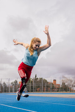 Paralympic athlete woman with bionic leg prosthesis running quick