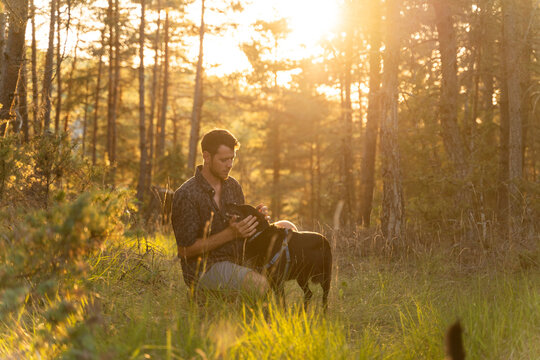 Man and dog at sunset in nature