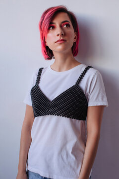 Young model in black bra over white shirt