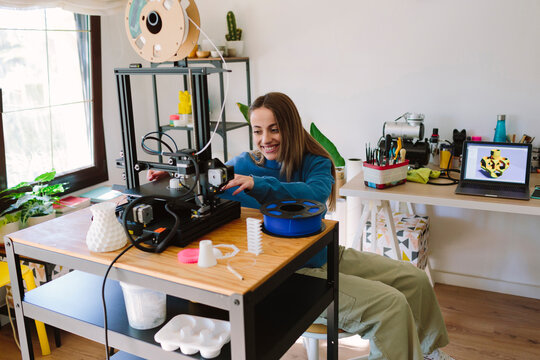 Smiling designer using a 3D printer