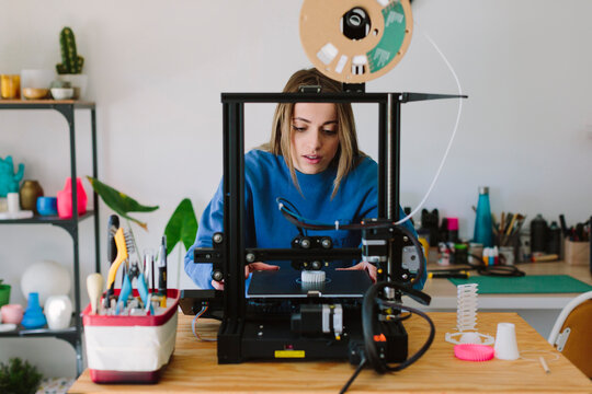 Woman using a 3d printer