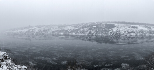 panorama of the winter river, it is raining snow, the dnieper river, the city of zaporozhye, the island of khortitsa