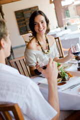 A young woman having dinner with a male partner