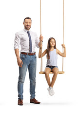 Full length portrait of a man standing next to a girl on a swing