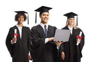 Students in graduation gowns holding a laptop computer