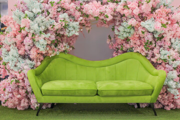 Green sofa in flower arch