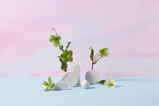 Stone geometric figures with green blooms.