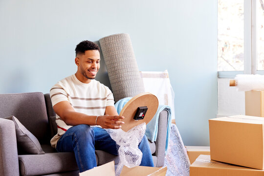 Positive young African American male in casual clothes smiling