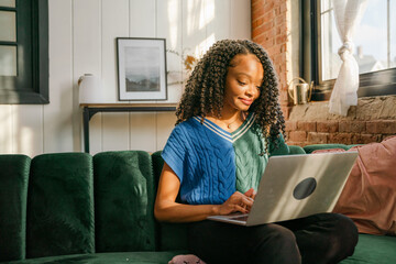 smiling young woman working on laptop  