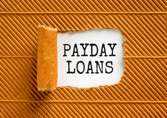 Payday loans symbol. Concept words Payday loans on beautiful white paper. Beautiful brown paper cardboard background. Business and Payday loans concept. Copy space.