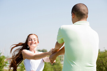 happy young couple paly at park, focus on the women