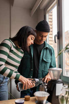 Cool couple making coffee at home
