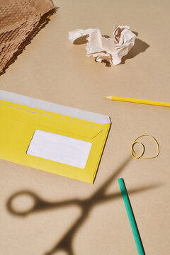 Opened envelope surrounded by various office trivia