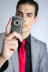 Fototapeta premium Businessman with gray suit taking photos with phone camera