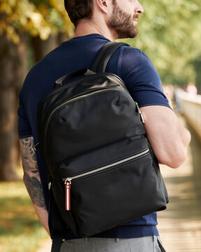 Man with a backpack on his shoulder close-up
