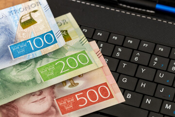 E-commerce business, Sweden, money on tablet keyboard, Shopping and online stores, concept, online marketplace, Secure Payments and bank transfers in Sweden