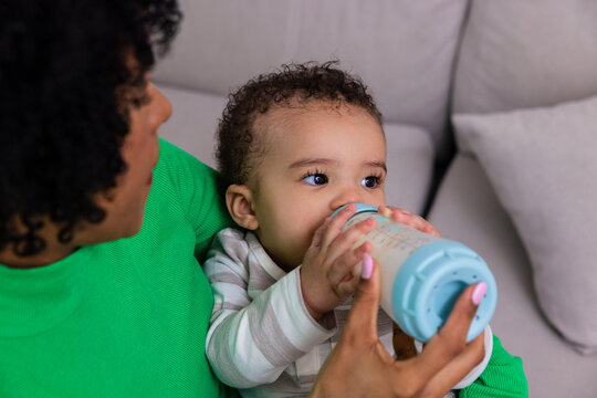 Latin mother bottle feeding her baby