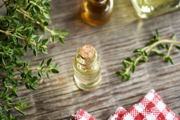 A bottle of aromatherapy essential oil with fresh thyme