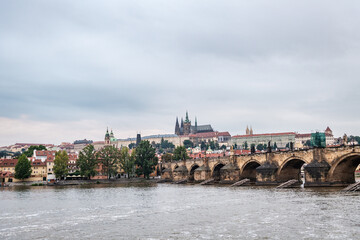 Fototapeta na wymiar Castle of Prague and Saint Vitus Cathedral as seen from the shore of the Vltava river at dusk.
