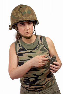 A serious soldier girl holding a hand grenade on white background
