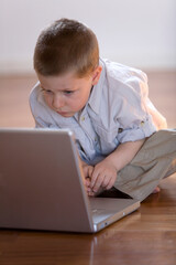 Child impatient waiting to learn with a computer at home