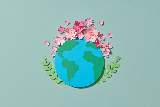 Planet Earth model papercraft on natural background.