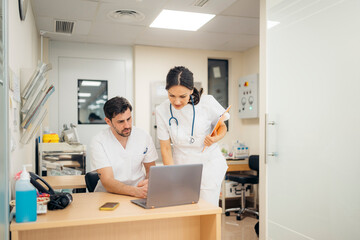 Staff of hospital working with laptop
