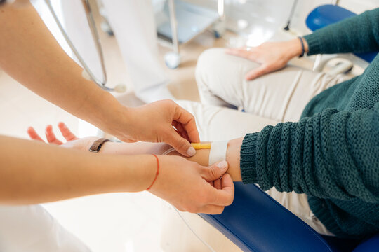 Anonymous doctor drawing blood from patient
