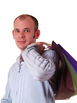 Young good looking man holding some shopping bags