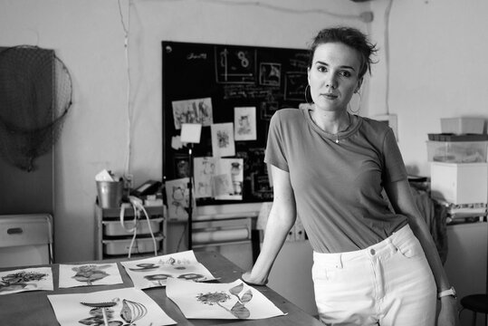 Female artist standing at her art studio
