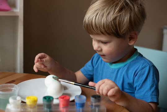 Boy Painting Easter Eggs