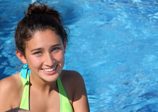 Pretty smiling teen girl in a pool