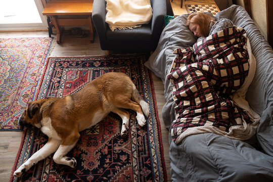 Woman and Dog Taking Nap at Winter Cottage