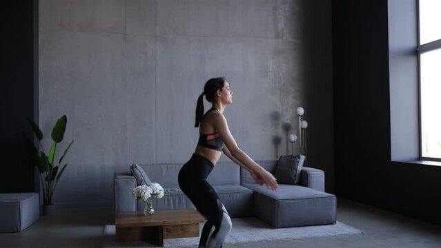 Young fitness woman  squat exercises at home