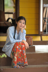 Fototapeta premium Malay girl pensive in traditional house