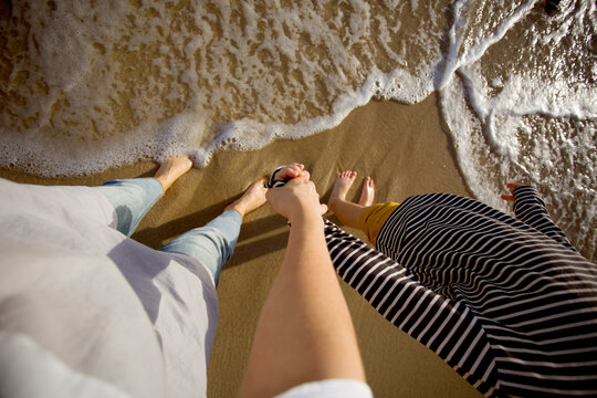 mother and son playing in the waves