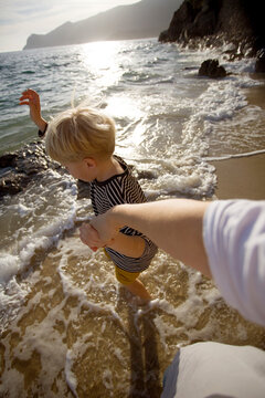 mother and son playing in the waves