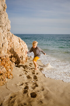 boy have a fun on the ocean cost beach
