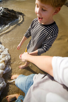 mother and son playing in the waves
