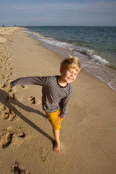 boy have a fun on the ocean cost beach