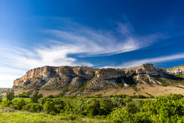 Rocky ledges, cuesta in hilly terrain, landscape on clear day