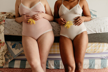 image of two unrecognizable women wearing bodysuits